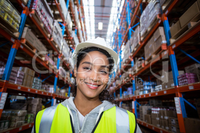 Smiling female worker holding clipboard