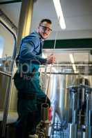 Happy Brewer holding working equipment