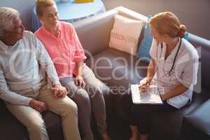 Nurse talking to senior couple