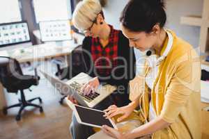 Two female graphic designer using digital tablet and laptop