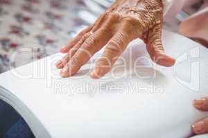Senior woman using braille to read