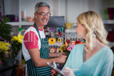Smiling florists interacting with each other