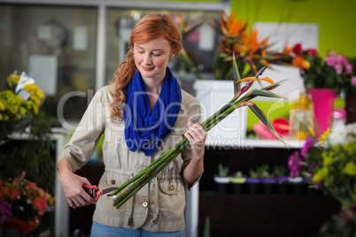 Female florist trimming flower stem