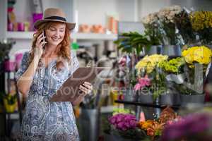 Female florist taking order on mobile phone