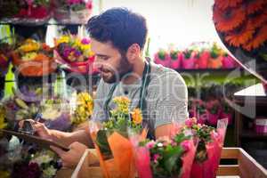 Male florist writing and making notes