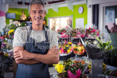 Male florist standing with arms crossed