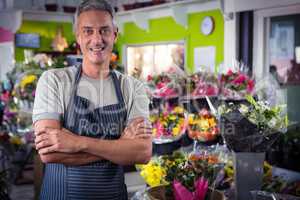 Male florist standing with arms crossed