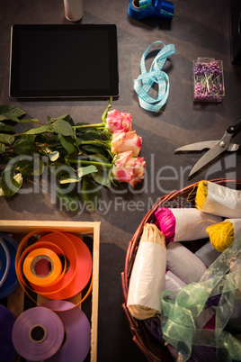 Digital tablet and florist supplies on the wooden table