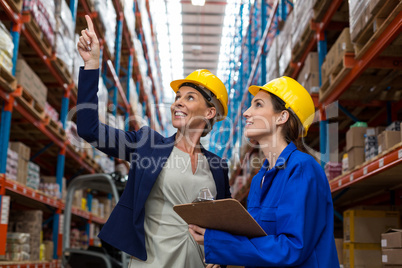 Female smiling coworkers looking up