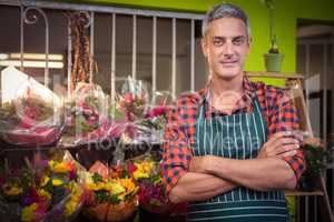 Male florist with arms crossed at flower shop