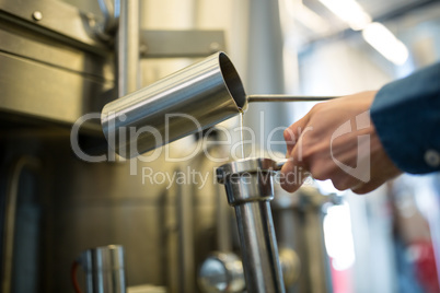 Brewer checking beer at brewery