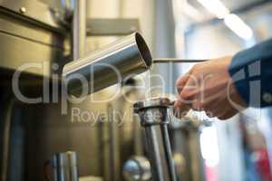 Brewer checking beer at brewery