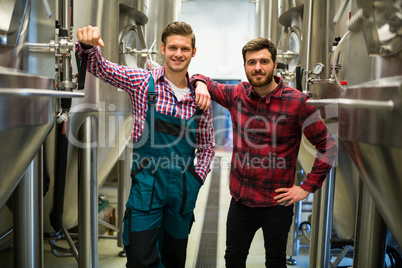 Brewers with arms crossed at brewery