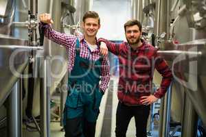 Brewers with arms crossed at brewery
