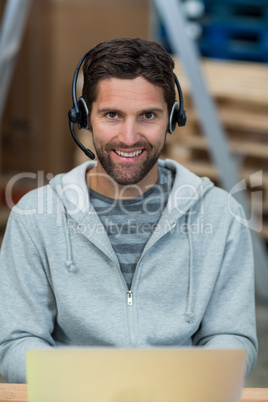 Portrait of a smiling worker wearing a headset