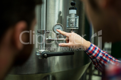 Maintenance workers examining pressure