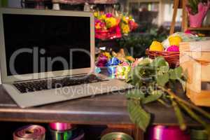 Laptop and florist supplies on the table