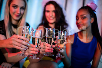 Group of smiling friend toasting glass of champagne