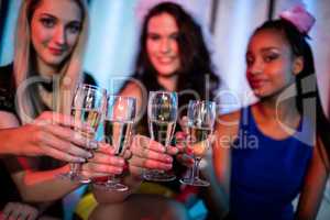 Group of smiling friend toasting glass of champagne