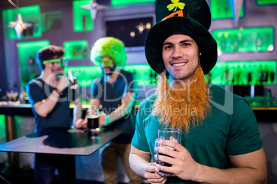 Man holding beer glass and smiling