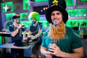 Man holding beer glass and smiling