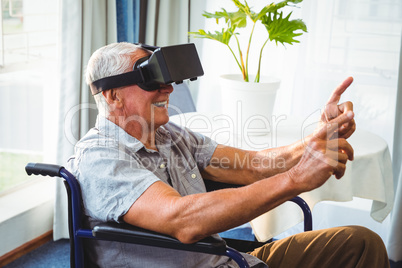 Senior man in a wheelchair using a virtual reality device