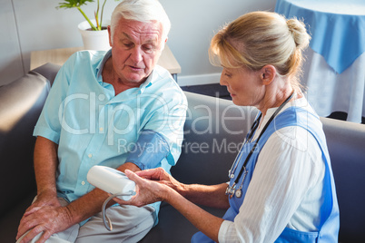 Nurse measuring the blood pressure of a senior man
