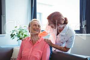 Nurse and senior woman looking at each other