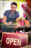 Male florist holding digital tablet at his flower shop