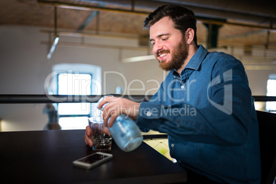 Man pouring water in glass