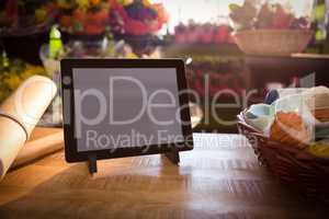 Wicker basket and digital tablet on the wooden table