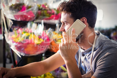 Male florist talking on mobile phone