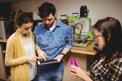 Team of graphic designers interacting using digital tablet