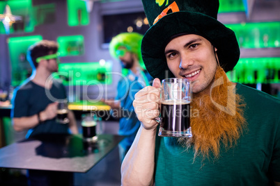 Man holding beer glass and smiling