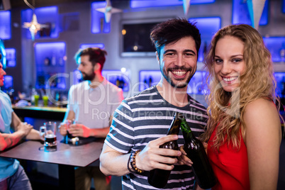 Happy couple toasting a beer bottles