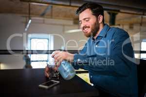 Man pouring water in glass