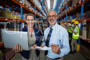 Businessmen using laptop and writing on pape