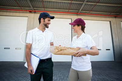 Portrait of delivery people are holding a cardboard box