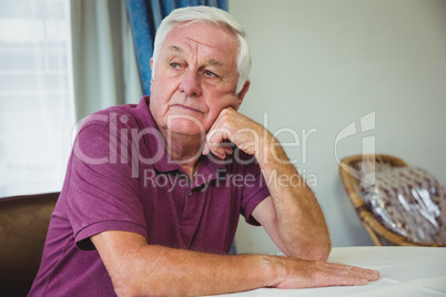 Senior man sitting at a table