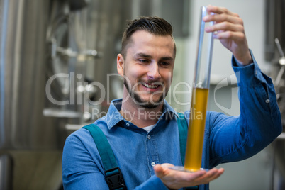 Brewer holding hydrometer cylinder