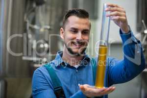 Brewer holding hydrometer cylinder