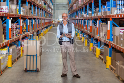 View of manager is smiling and posing to the camera during work