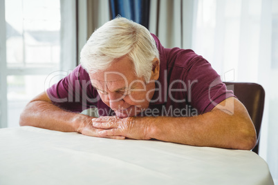 An old man is lying on the table