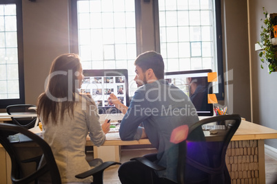 Graphic designers working at desk in the office