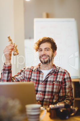 Happy graphic designer holding a wooden block