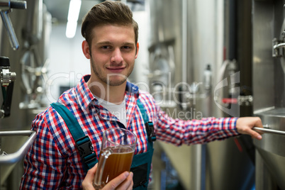 Brewer holding pint of beer