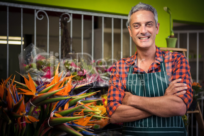 Male florist with arms crossed at flower shop