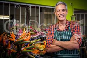 Male florist with arms crossed at flower shop