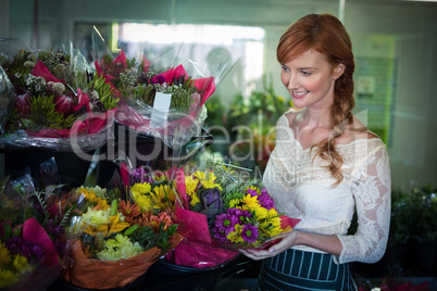 Female florist arranging flower bouquet