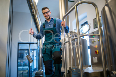 Brewer holding working equipment at brewery